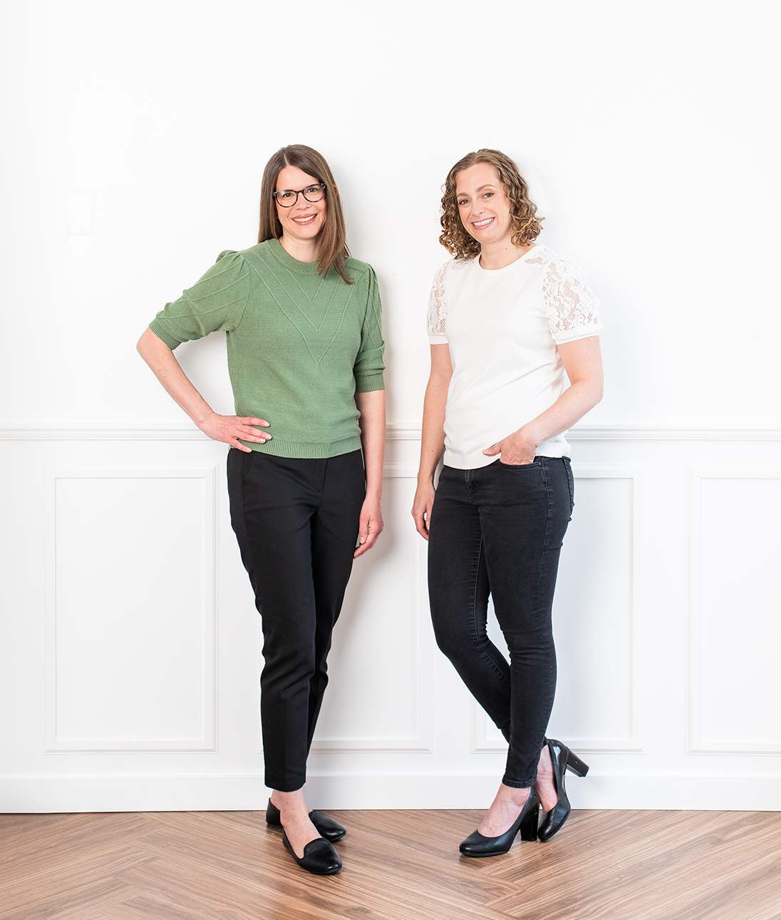 Kelley and Andrea of Inkling Design standing against a white wall